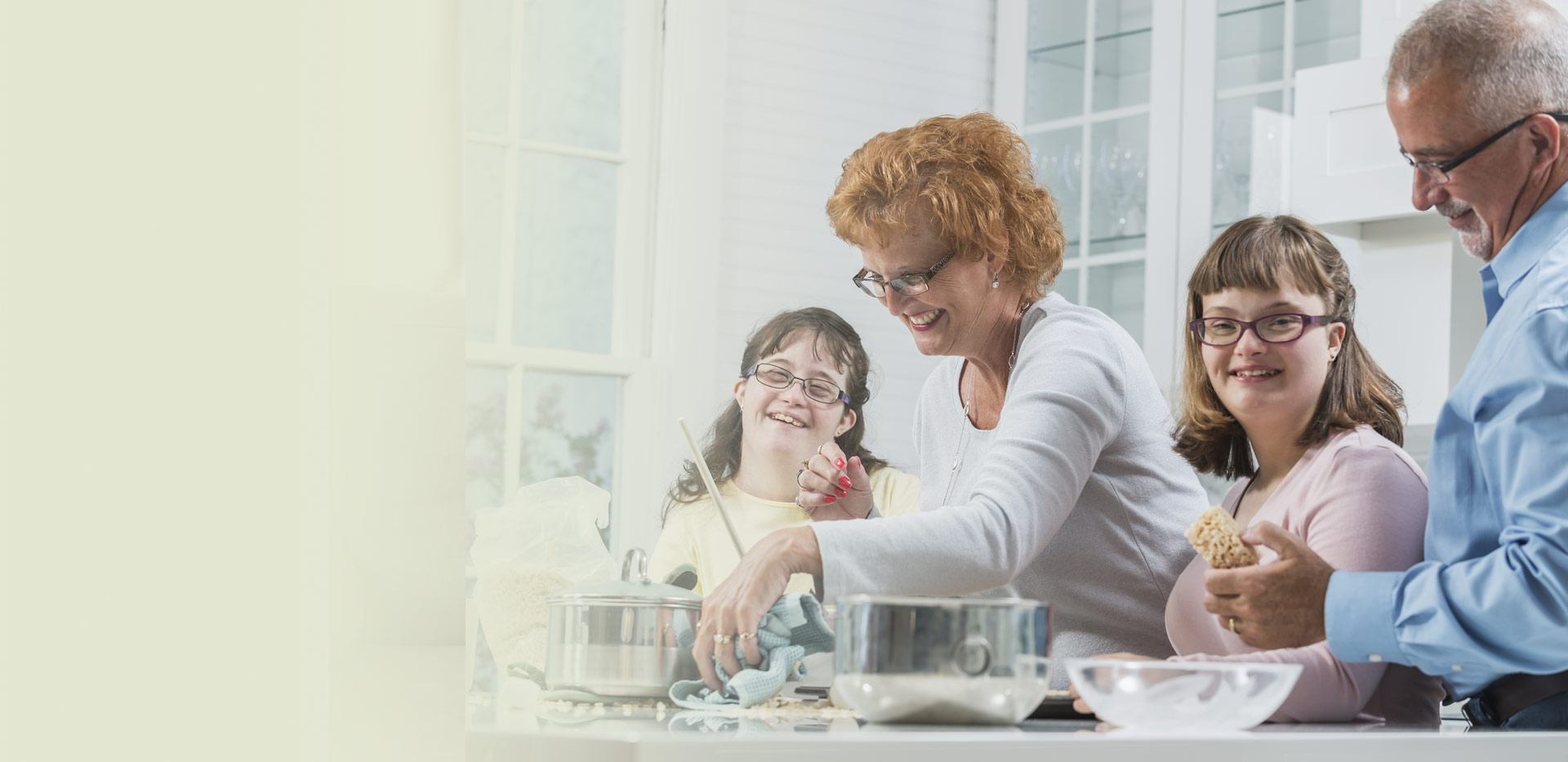 A family laughing together in the kitchen